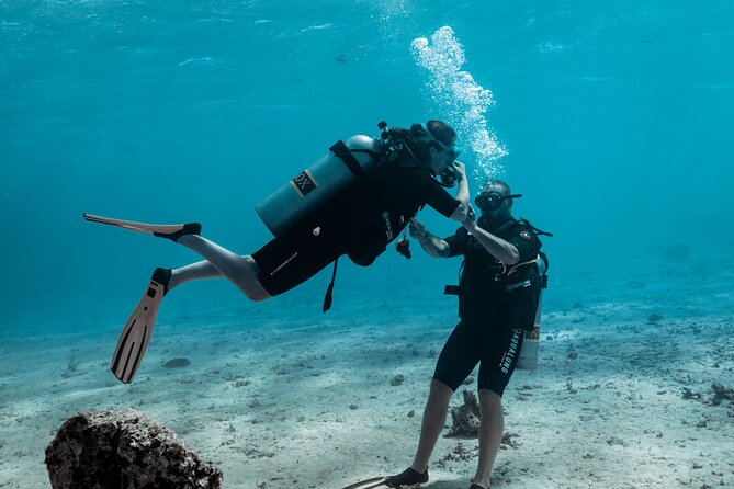 Baptism diving in the turquoise waters of Tahiti - Why the two-person limit matters